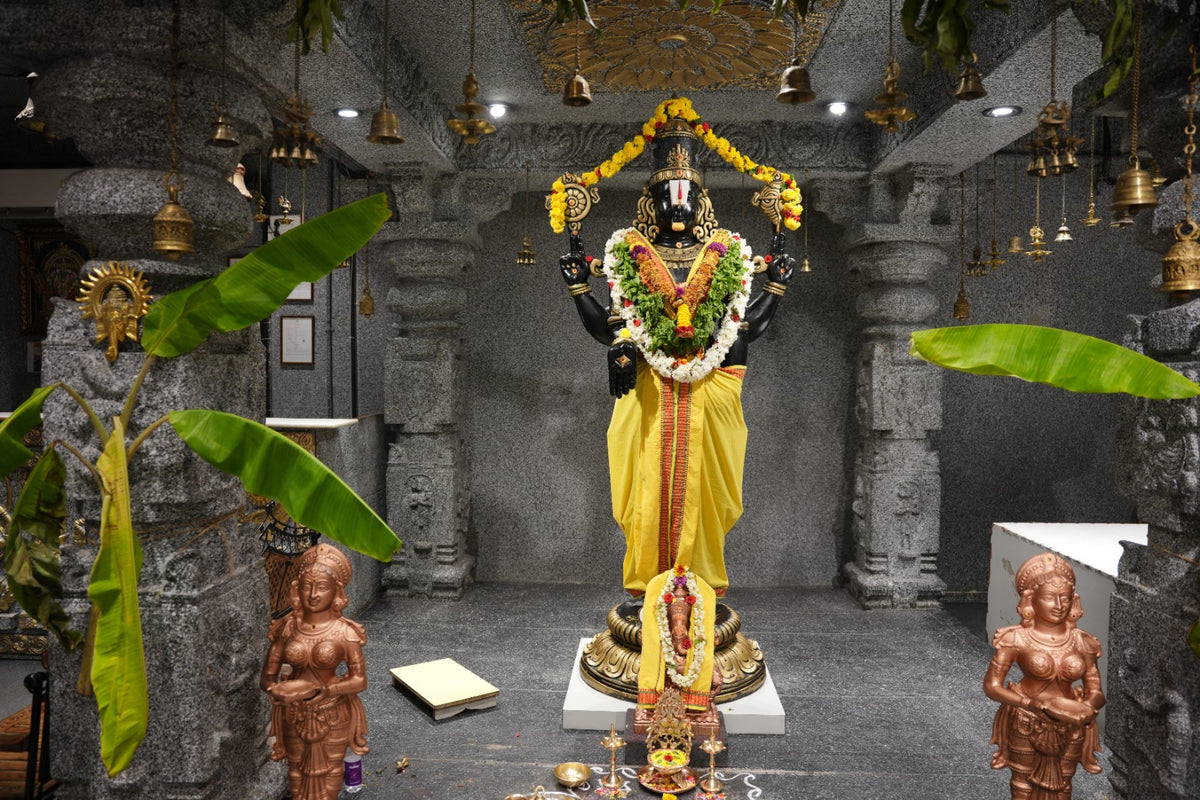 The Balaji temple inside a Mugdhaa store, with brass bells, banana leaves and lamps